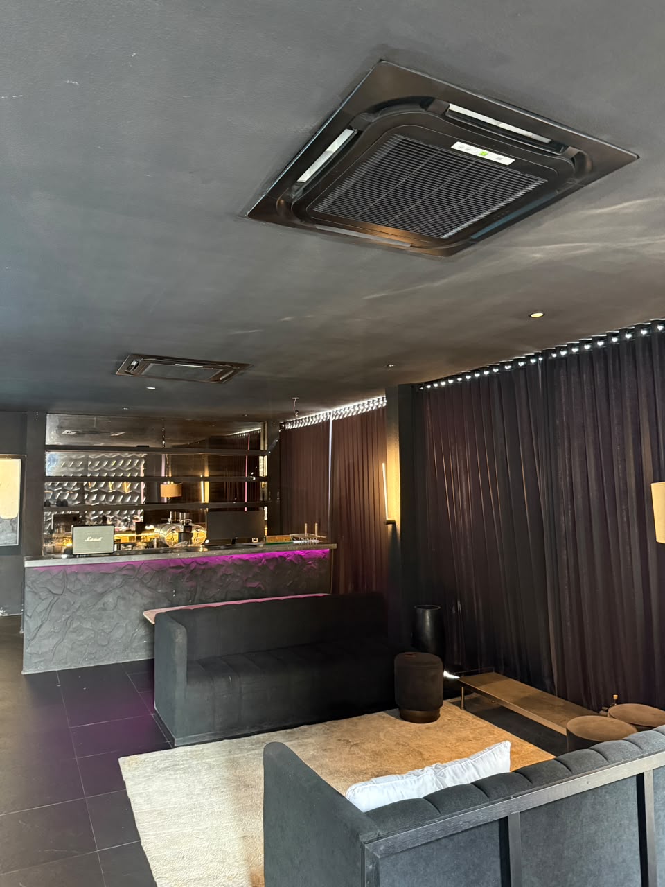 The existing black interior and bar at Maya Canggu